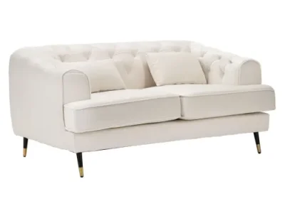 Estila Art deco dvojmiestna čalúnená zamatová krémová sedačka Lana s čiernymi nožičkami so zlatými detailmi 146 cm